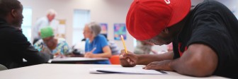 A GED student works in class.