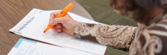 A Seeds of Literacy tutor grades a student's work.