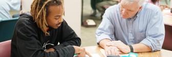 A tutor helps an evening GED student.