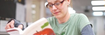 A female student reads a book at Seeds of Literacy.
