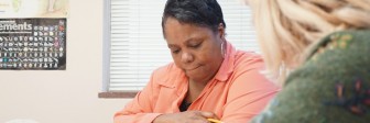 A GED student works with a tutor at Seeds of Literacy.