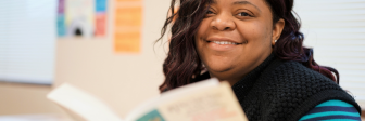 A GED student reads a book at Seeds of Literacy